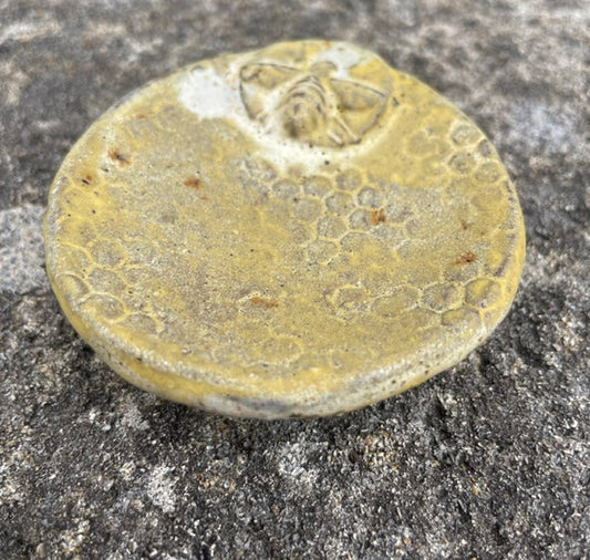 Bee Merry yellow pottery incense holder with bee motif on honeycomb texture